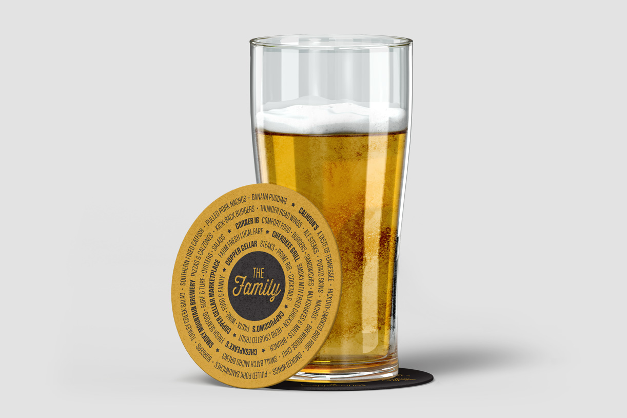 Glass of beer with a drink coaster covered with typography