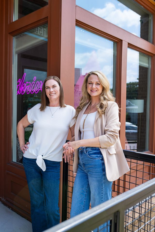 Brookney Chamberlain and Stacey DeHart - co-managing partners of Asen Marketing posed outside of Asen Marketing's front door in Knoxville, TN. Asen Marketing is a comprehensive marketing agency in Knoxville, TN.